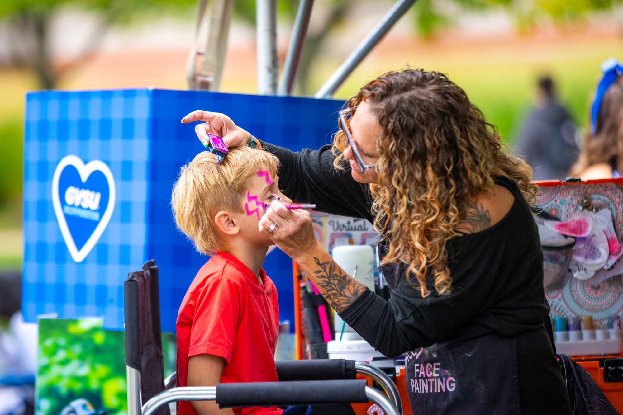 Boy getting his face painted